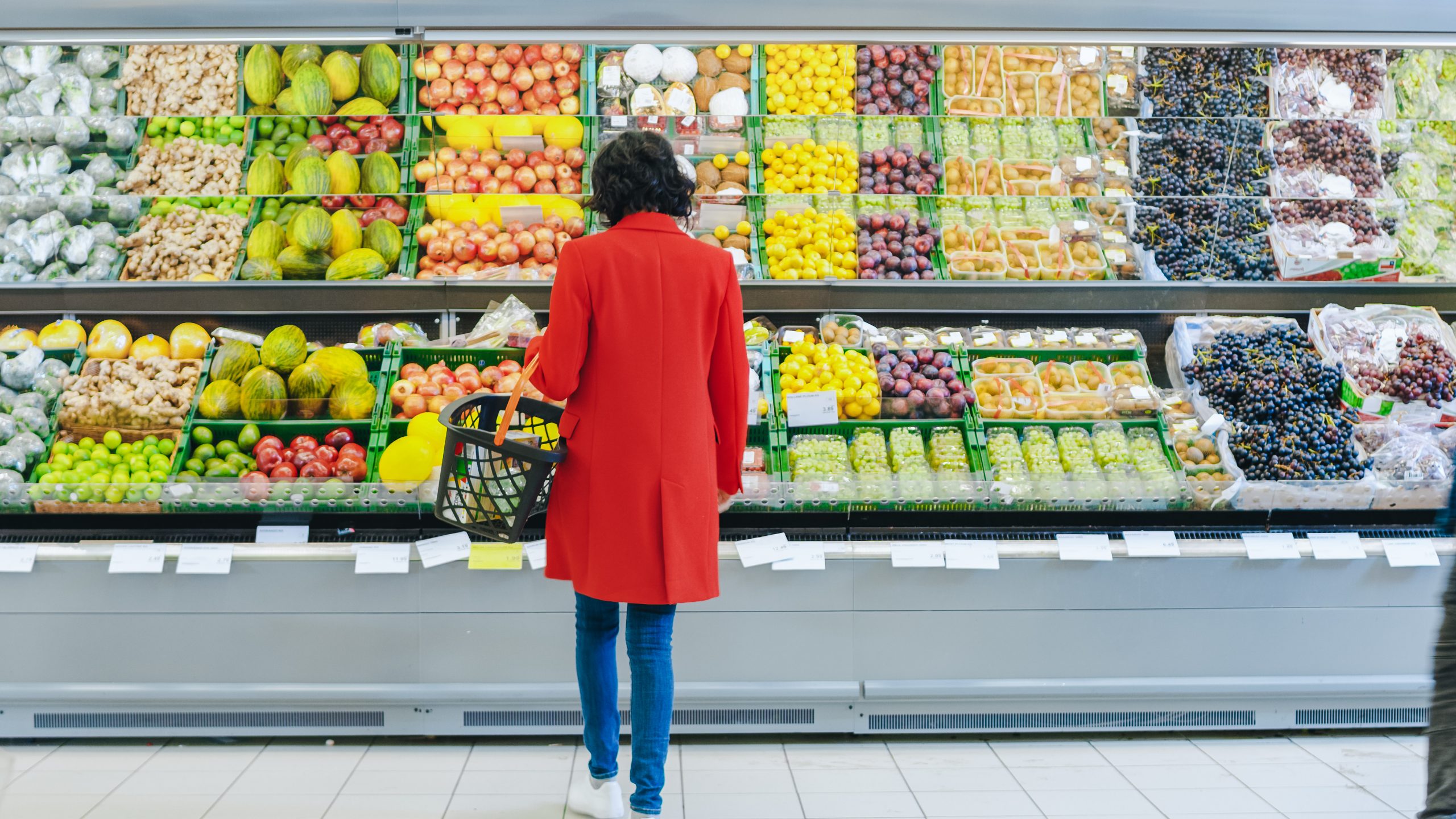 At the Supermarket: Alone Woman Chooses Organic Fruits in the Fr